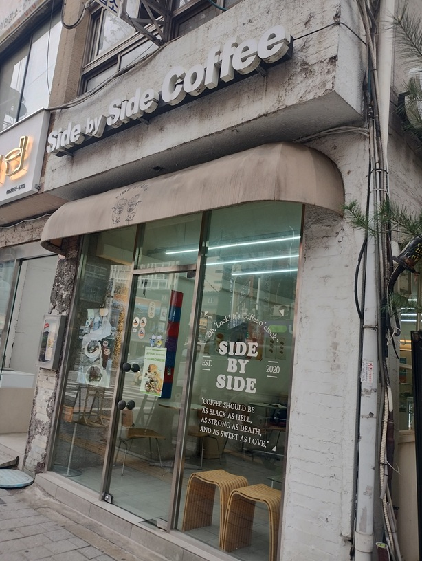 韓国ソウル明洞の近くにある有名な喫茶店Ｓｉｄｅ　ｂｙ　Ｓｉｄｅ　Ｃｏｆｆｅｅのお店。テントにはキャラクターの恐竜
